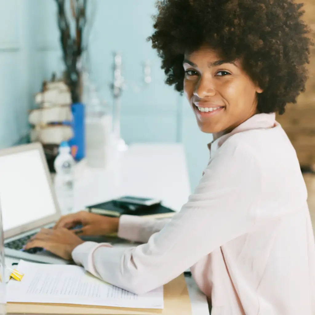 Smiling business professional viewing LinkedIn automation dashboard with positive metrics.